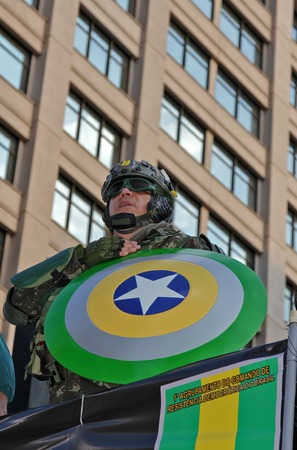 SAO PAULO, BRAZIL August 16, 2015: An unidentified man dressed as a super hero with colors yellow and green in the protest against federal government corruption in Sao Paulo Brazil.のeditorial素材