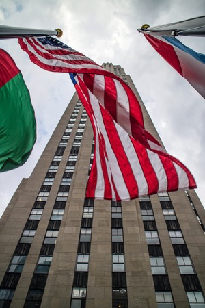 Rockfeller Center Building Perspective with flags Manhattanのeditorial素材
