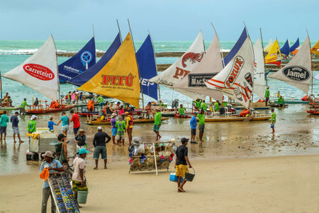 Pernambuco, Brazil July 6, 2016: An unidentified group of people in Chicken Beach with typical sail boats in Ipojuca City, northeast Brazilのeditorial素材