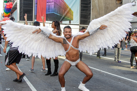 SAO PAULO, BRAZIL - June 18, 2017: An unidentified young man dressed in a costume with wings celebrating lesbian, gay, bisexual, and transgender culture in the 21st Gay Pride Parade Sao Paulo.のeditorial素材