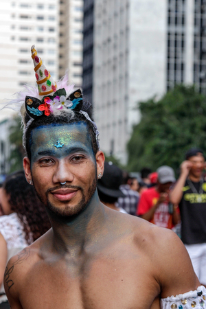 SAO PAULO, BRAZIL - June 18, 2017: An unidentified young man dressed in a costume celebrating lesbian, gay, bisexual, and transgender culture in the 21st Gay Pride Parade Sao Paulo.のeditorial素材