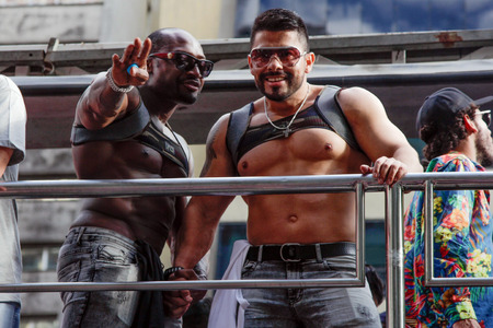 SAO PAULO, BRAZIL - June 18, 2017: An unidentified young men dressed in a costume celebrating lesbian, gay, bisexual, and transgender culture in the 21st Gay Pride Parade Sao Paulo.のeditorial素材