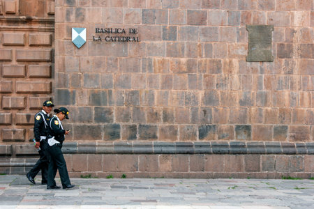 Cuzco, Peru - September 9, 2018: Unidentified police officers working in front of the old catholic...