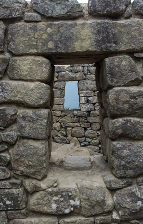 Window on Machu Pichuu on a cloudy day. Cuzco, Peru. Stones carved for a perfect assembly.の写真素材