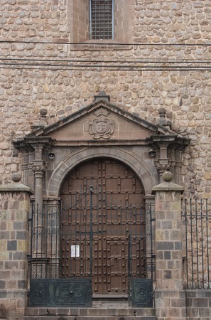 Detail of an old catholic church facade in Cuzco Peru. Old door.の写真素材