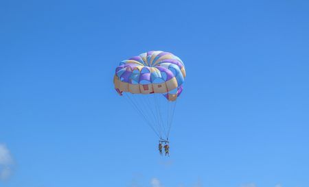 Punta Cana, Dominican Republic - October 24, 2018: Unidentified people flying with paragliding on the beach of Bavaro at Punta Cana region in a sunny day.のeditorial素材