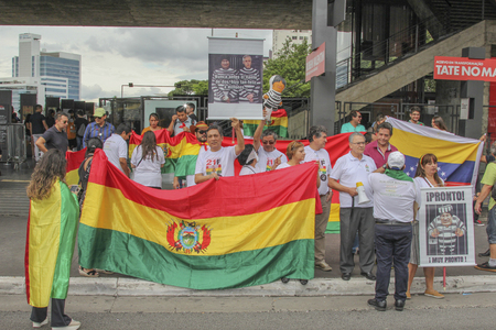 Sao Paulo, Brazil - February 17,2019: Unidentified group of people in a manifestation against the current government of Bolivia, with flags and cards.のeditorial素材