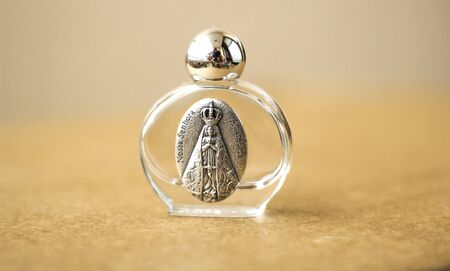 Aromatic home spray air freshener in a transparent mini glass bottle with decorationの写真素材