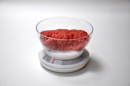 A pound of ground beef  is on a scale の写真素材