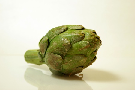A artichoke is displayed on a plain background.の写真素材