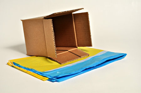 A brown cardboard box sits on top of tissue paper.