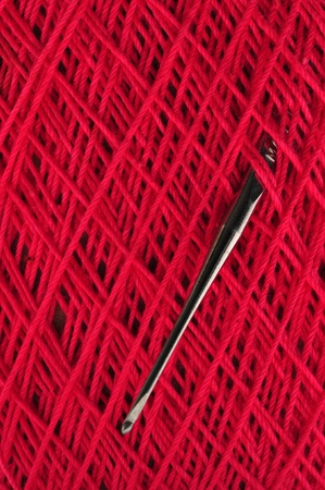A crochet needle is struck in a ball of crochet thread.の写真素材
