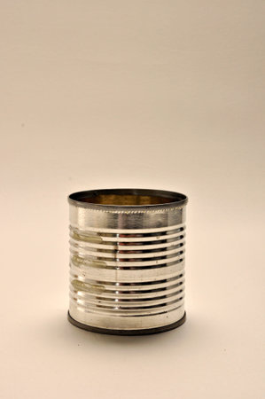 A tin can is on a plain white background 