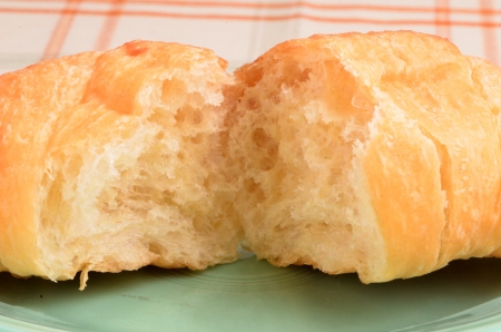 Closeup image of a croissant that has been torn apart.の写真素材