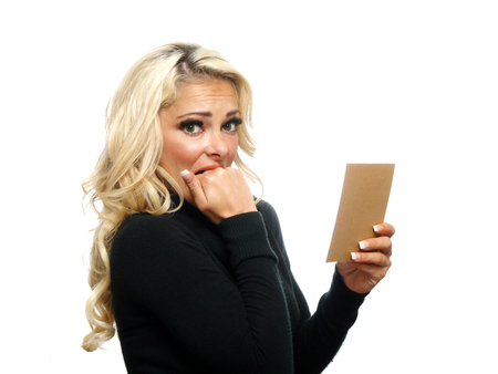 A attractive blond woman sees her bill and is afraid,の写真素材