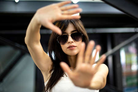 girl in black glasses waves her handsの写真素材