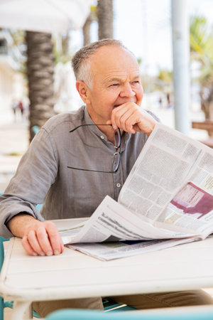 Vintage lifestyle, senior man with newspaperの写真素材