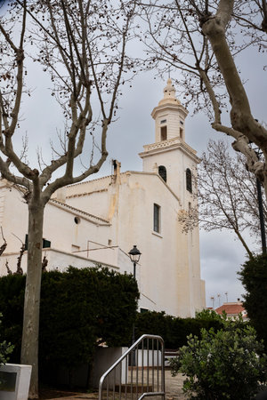 White church tower on a cloudy day in Menorca, Spainの写真素材
