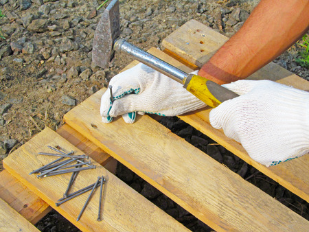 Hammer, nail and hand.の写真素材