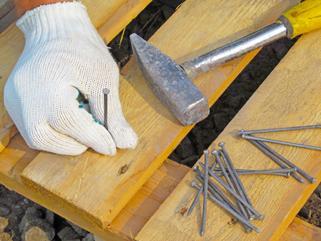 Hammer, nail and hand.の写真素材