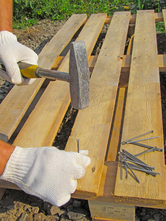 Hammer, nail and hand.の写真素材