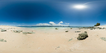 Ocean waves over the white sand beach in Hagonoy Island. Britania Island. Surigao de Sur,...