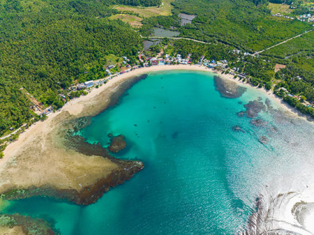 Beautiful white sand in tropical island coastline. Turquoise water and barrier reefs. Mindanao, Philippines. Travel concept.の写真素材