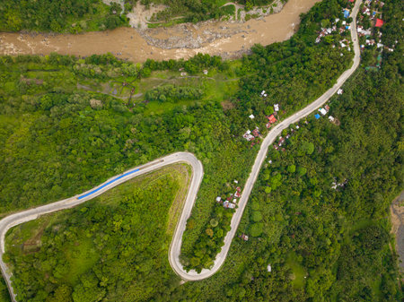 Top view of asphalt curve road in tropical mountain. Mindanao, Philippines.の写真素材