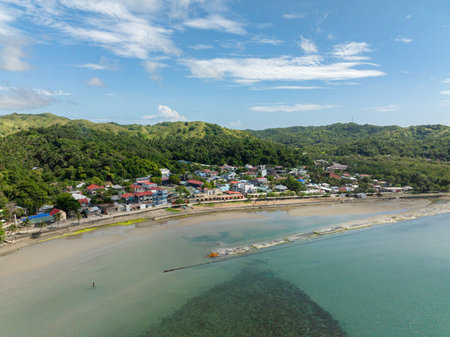 Aerial view of coastal town in Santa Fe with turquoise sea water. Tablas, Romblon. Philippines.