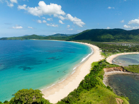 Clear turquoise water and sea waves on sands. Nacpan Beach. El Nido, Palawan. Philippines.