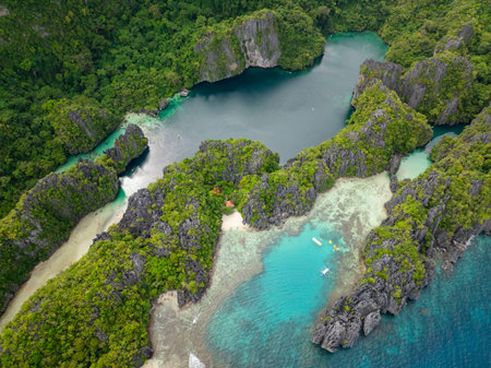 Big and Small Lagoons with kayaks over clear water. Miniloc Island. El Nido, Palawan. Philippines.