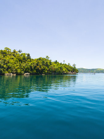 Tropical Island with green plants and blue sea. Surigao del Norte, Philippines.の写真素材