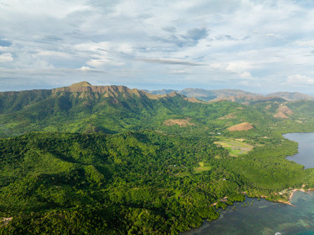 Aerial view of Mountains covered rainforest and trees. Blue sky with clouds. Coron, Palawan. Philippines.の写真素材