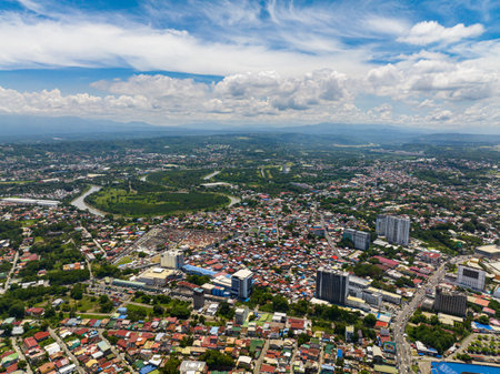 Beautiful blue sky and clouds above in Davao City. Aerial view of River and cityscape of Davao City. Mindanao, Philippines.の写真素材