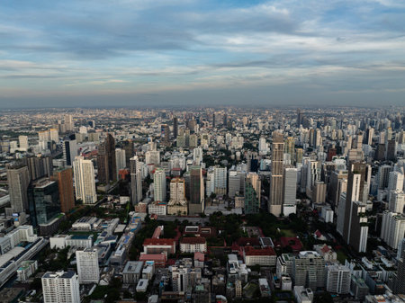 Evening view of the Bangkok skyline with illuminated skyscrapers and dense urban landscape under a...
