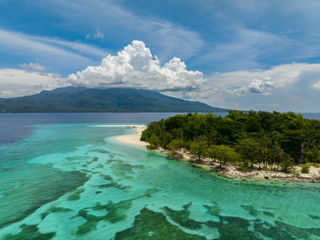 Natural beauty of Mantigue Island. Clear turquoise water and corals in atoll. Camiguin, Philippines.