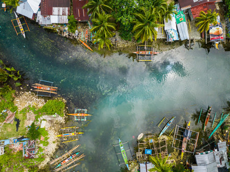 Drone view of Fishermans villages and clear cold spring river in Surigao del Sur. Philippines.