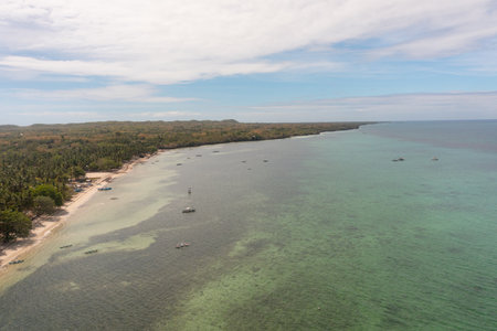 Island with beaches, fishing boat on clear sea water. Bantayan Island, Cebu, Philippines.の写真素材