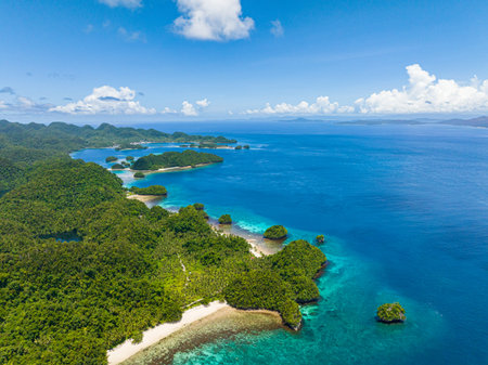 Coastline with white sand beach. Blue sea under blue skies. Seascape. Bucas Grande Island. Mindanao,...