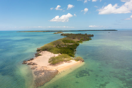 Island surrounded by coral reefs. Sandy beaches in Bantayan, Cebu. Boat running on water. Philippines.の写真素材