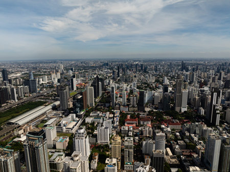 Urban skyline featuring modern buildings and residential towers, clear skies in the background....