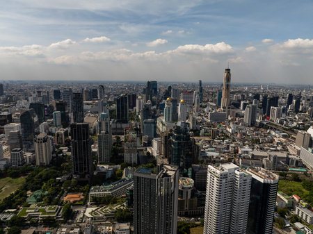 A diverse cityscape of Bangkok showcasing both modern skyscrapers and older structures under a...