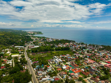 Iligan City with houses near at coast. Northern Mindanao, Philippines.