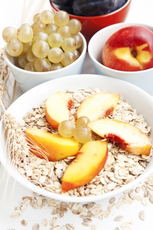 healthy breakfast with peaches,grapes,plums and cerealsの写真素材