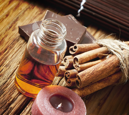 Essential Oil Bottle with Cinnamon Sticks and Chocolate.Aromatheraphy Settlementの写真素材