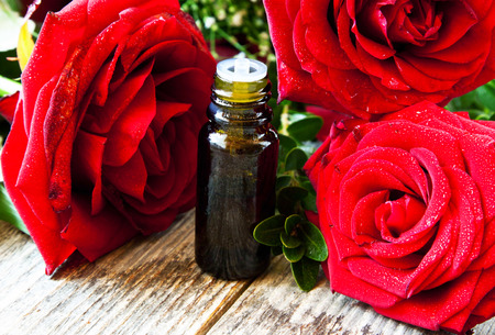 Red Roses Essence, Aromatherapy Essential Oil Bottle and Beautiful Red Rosesの写真素材