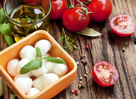 Fresh Mediterranean Ingredients,Mozzarella, Basil, Olive Oil, Tomatoes and Spices for Italian Cooking Recipeの写真素材