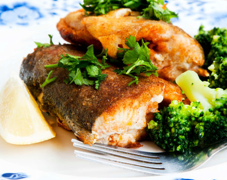 Freshly Prepared Trout Fish with Broccoli and Parsley Garnish