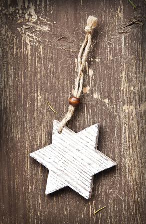 Vintage Wooden Star Christmas Decoration on Wooden Backgroundの写真素材