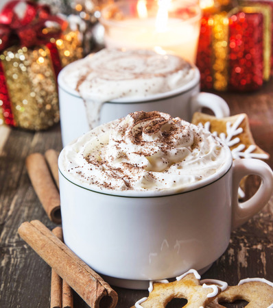 Coffee Cups with Whipped Cream, Cocoa Powder and Cinnamon with Gingerbreadの写真素材